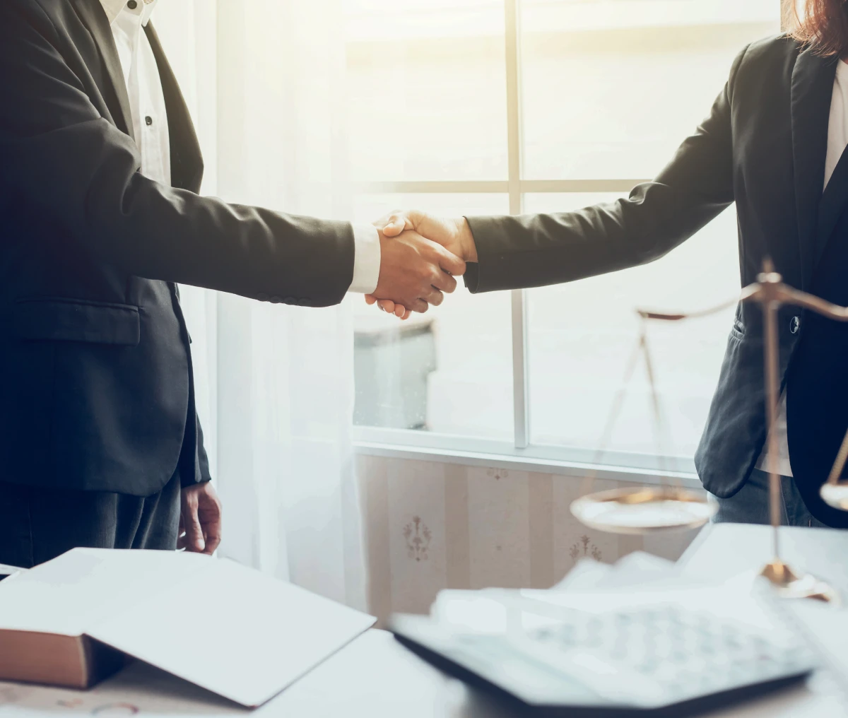 Business handshake in office setting